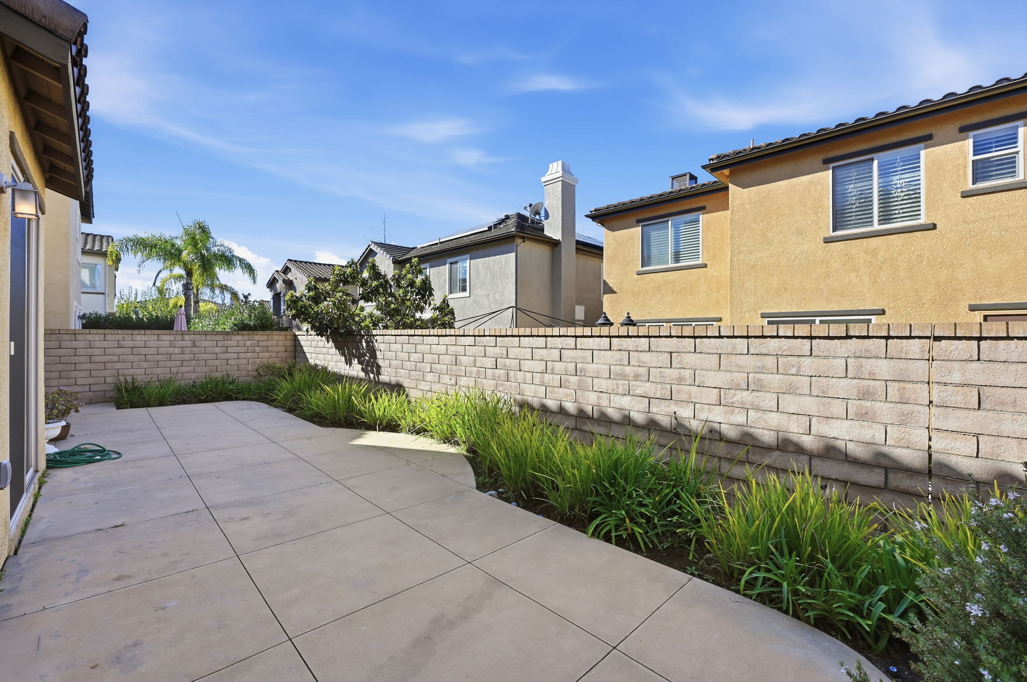 Backyard patio and side yard of a San Diego home, the kind of space where an ADU is built