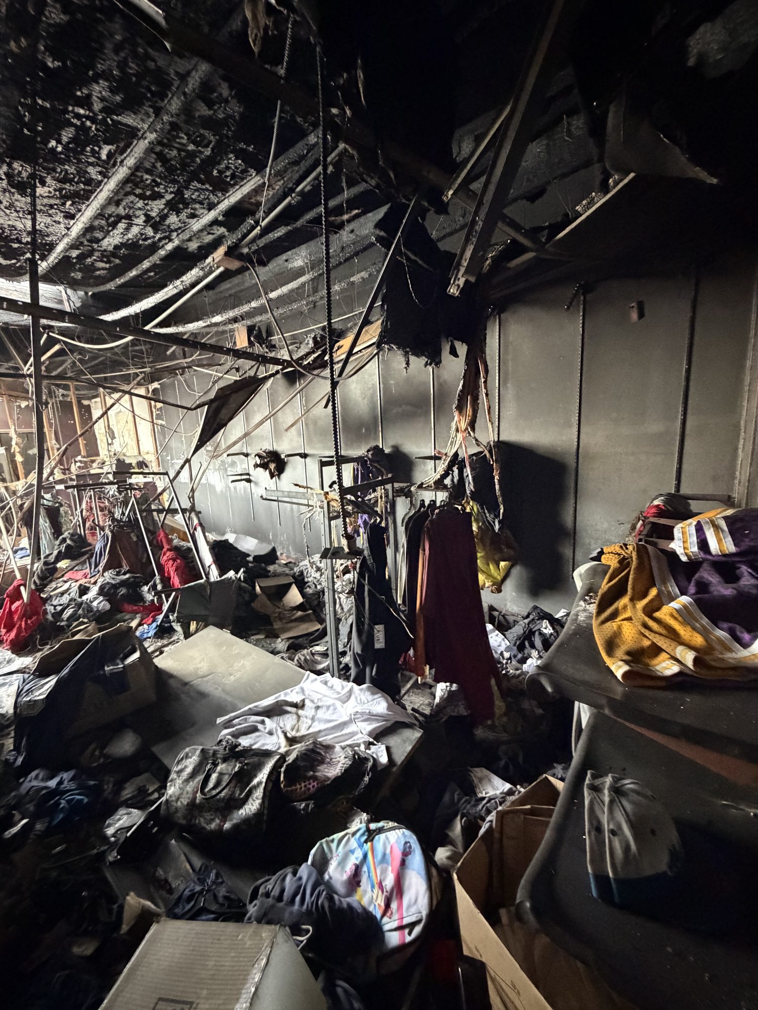 fire-damage-09-interior-charring Collapsed ceiling and charred merchandise inside a fire-damaged San Diego retail space