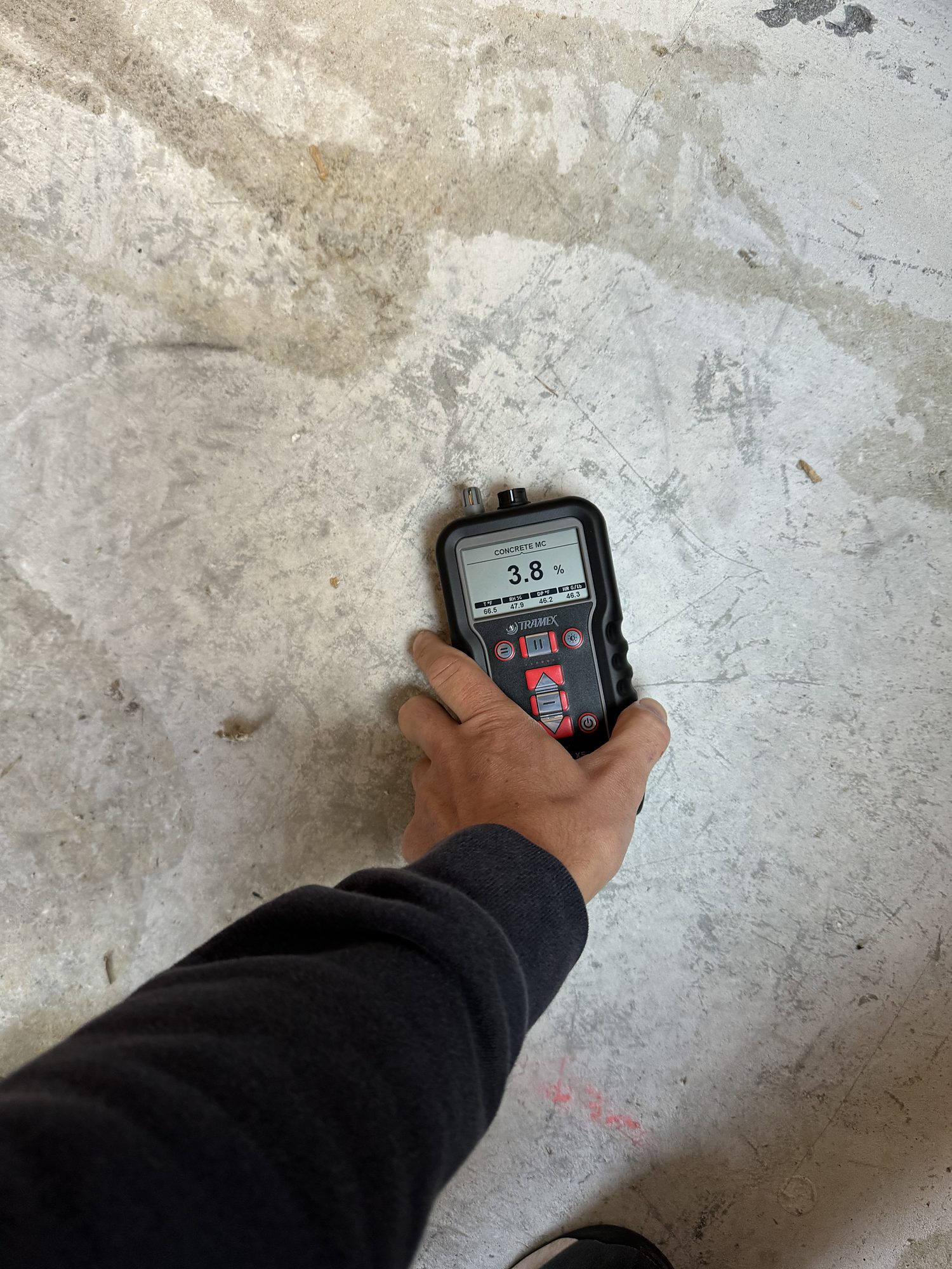fire2-23-concrete-moisture-reading-detail Moisture reading taken on a concrete slab to confirm drying progress during water damage restoration in San Diego