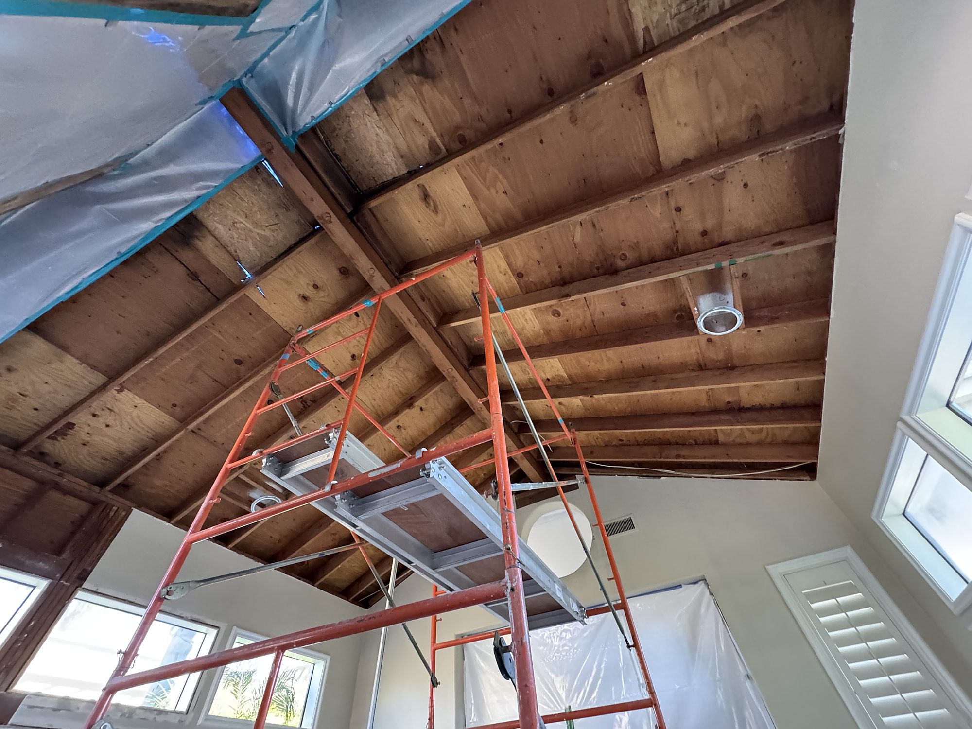 Exposed vaulted ceiling framing during reconstruction of a fire-damaged San Diego home