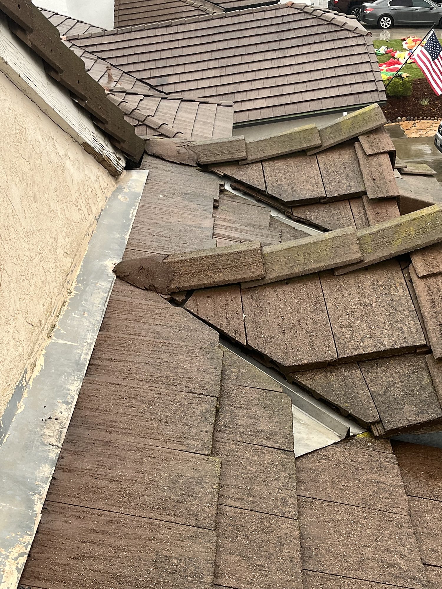 rooftarp-05-tile-damage-detail Displaced and cracked concrete roof tiles leaving the underlayment exposed after wind damage in San Diego
